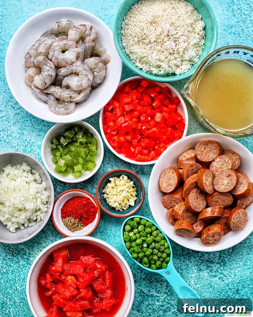 Seafood Jambalaya: A Ninja Foodi Delight 3 An array of fresh ingredients for seafood jambalaya, including sausage, vegetables, spices, and seafood.