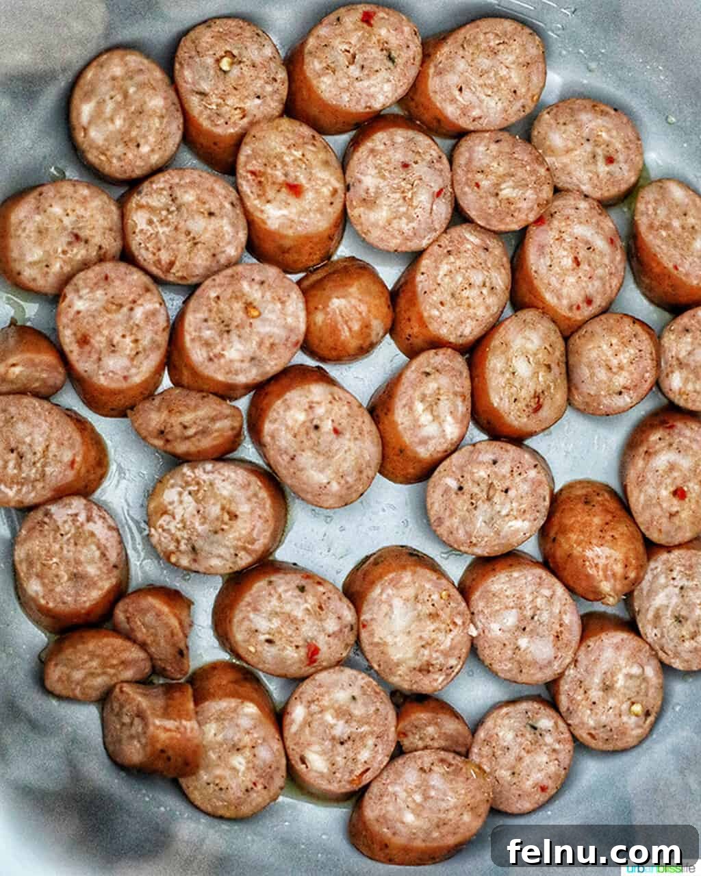 Seafood Jambalaya: A Ninja Foodi Delight 4 Sausage being sautéed in a Ninja Foodi pressure cooker, creating a flavorful base for the jambalaya.