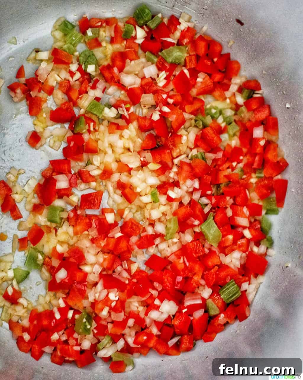 Seafood Jambalaya: A Ninja Foodi Delight 6 The 'Holy Trinity' of Cajun cooking – onions, celery, and bell peppers – sautéing in the Ninja Foodi, releasing their aromatic flavors.