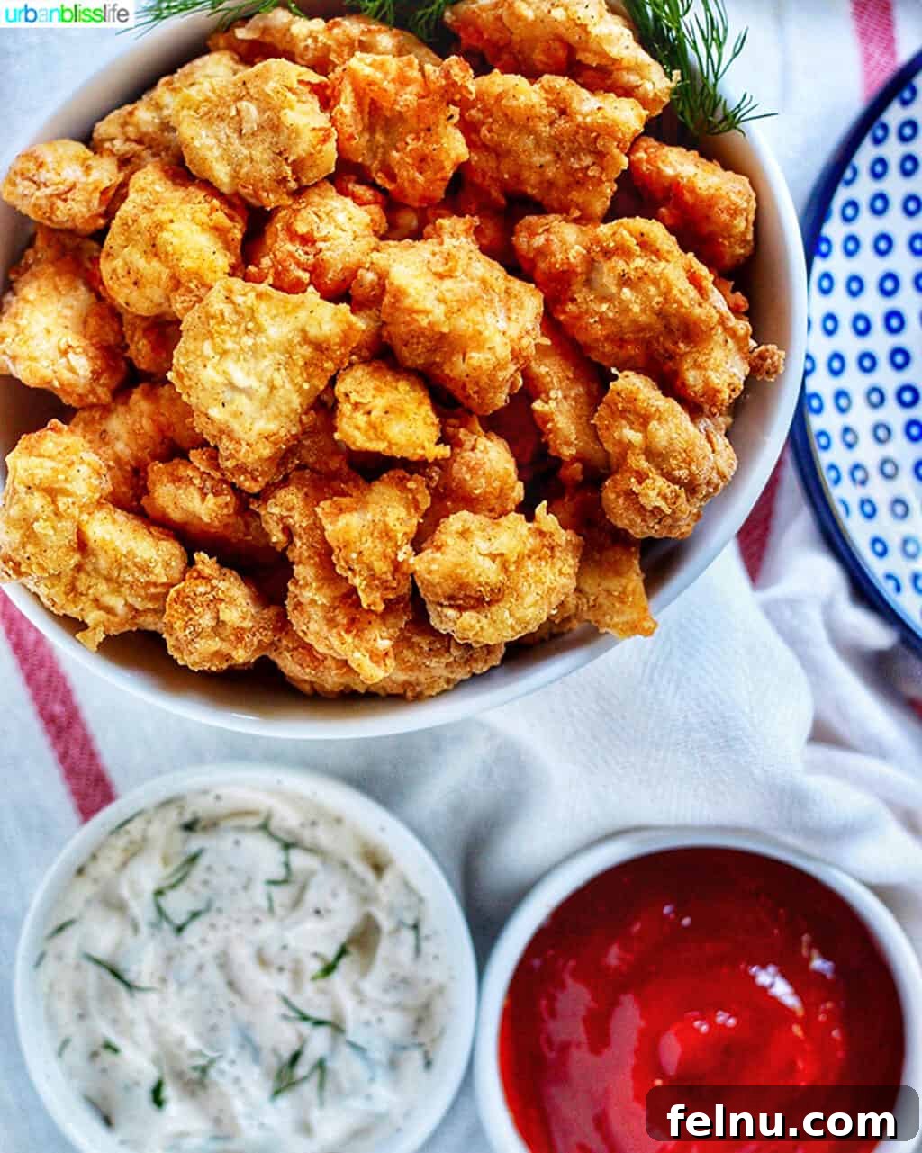 Mastering Ninja Foodi Pressure Cooker Meal Prep Cookbook 19 Crispy air fryer popcorn chicken served with two dipping sauces.