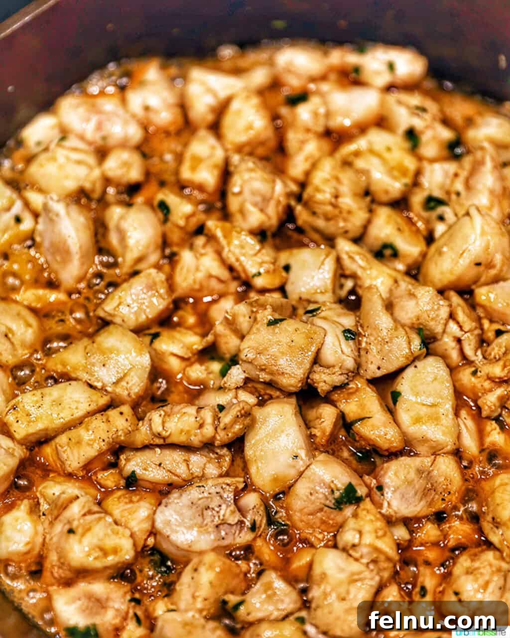 Golden Garlic Butter Chicken Morsels 7 Soy garlic butter chicken bites cooking in a cast iron pan, showing the rich sauce