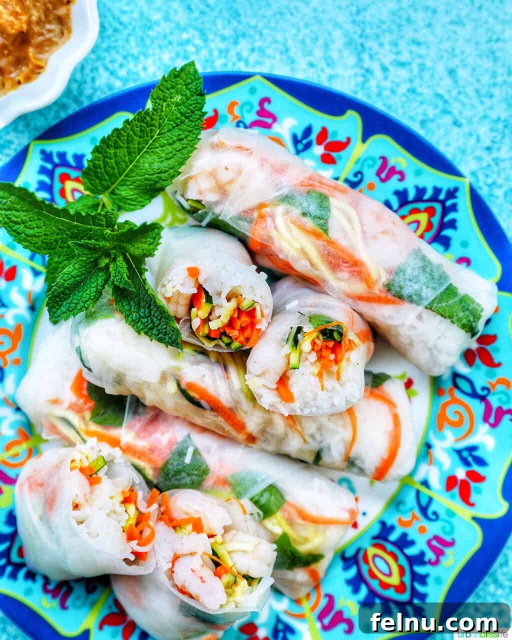 Freshly made shrimp summer rolls arranged on a plate.