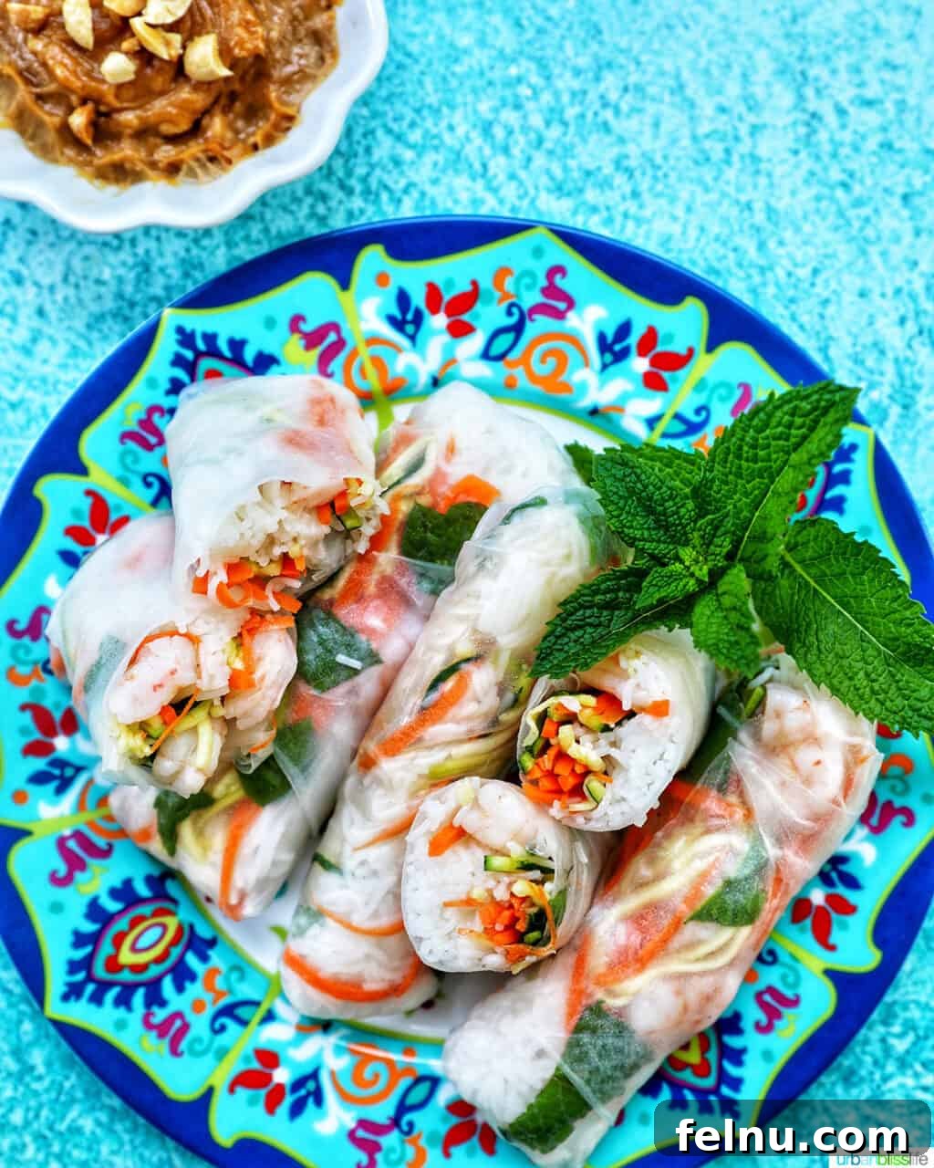 Shrimp summer rolls served with a side of homemade peanut sauce.