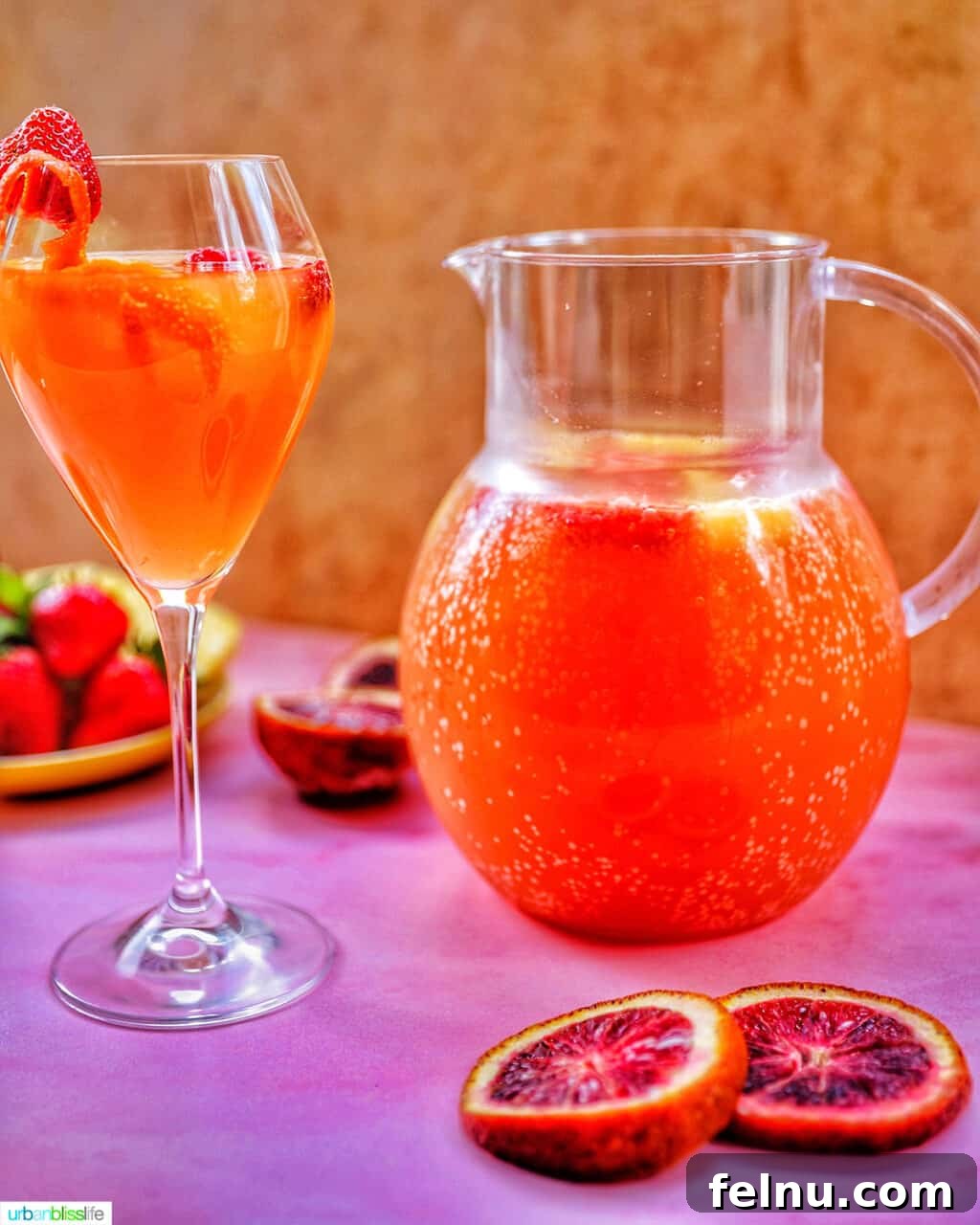 Tropical Sangria Bliss 6 Glass and pitcher of tropical sangria on a pink table