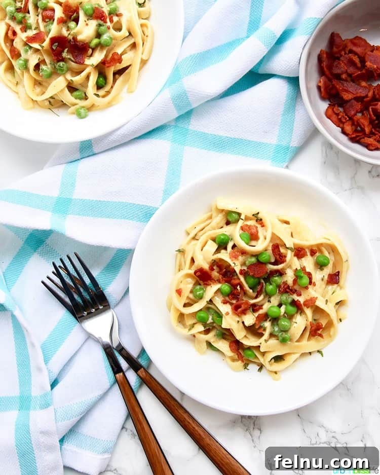 Creamy Bacon & Pea Pasta (Dairy-Optional) 4 Two bowls of Dairy-Free Fettuccine with Bacon and Peas ready to be enjoyed