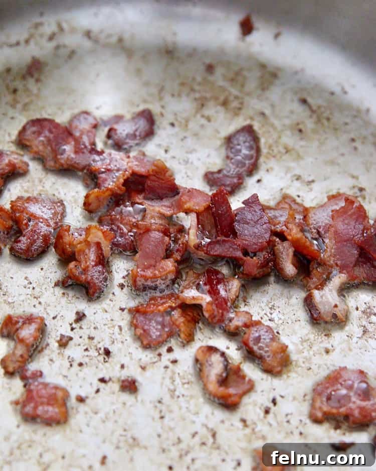 Creamy Bacon & Pea Pasta (Dairy-Optional) 5 Crispy bacon being cooked in a skillet