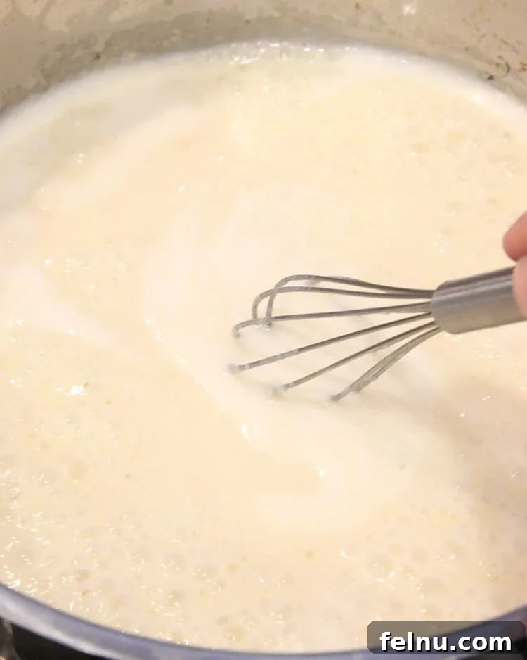 Creamy Bacon & Pea Pasta (Dairy-Optional) 6 Stirring the dairy-free cream sauce