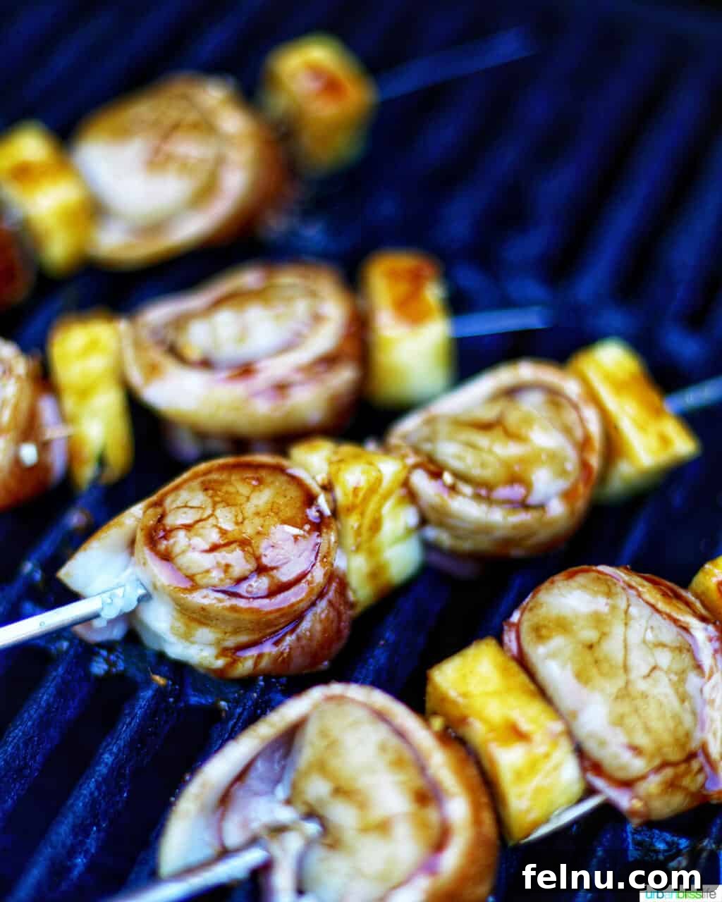 Bacon Bliss Teriyaki Scallops 5 Grilled bacon-wrapped scallop skewers with pineapple on the grill