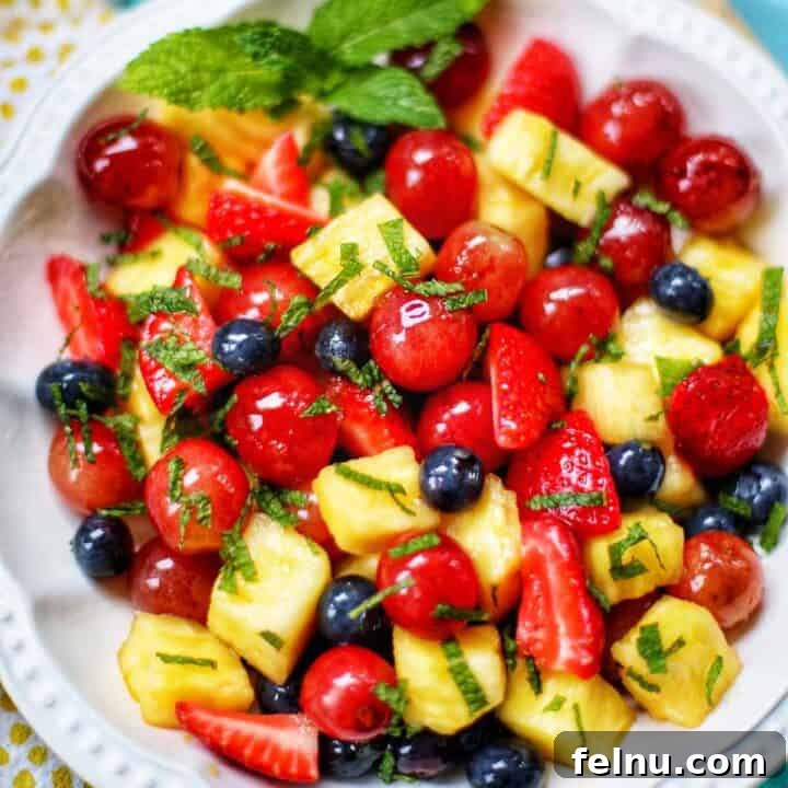 easy fruit salad with strawberries, blueberries, grapes, and pineapple.