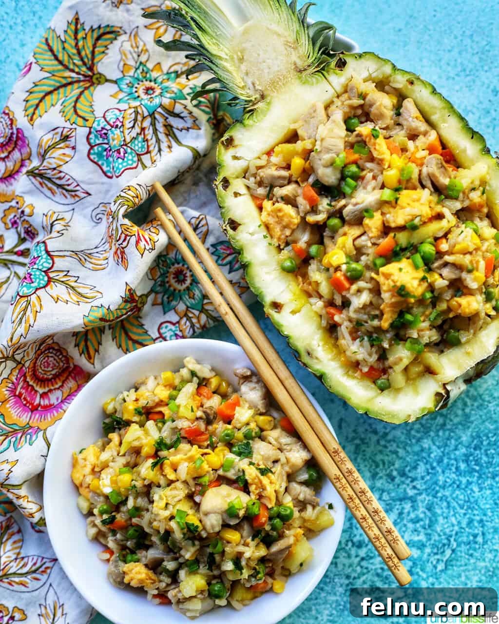 Pineapple Paradise Chicken Fried Rice 16 chicken pineapple fried rice in hollowed out pineapple boat with bowl of fried rice