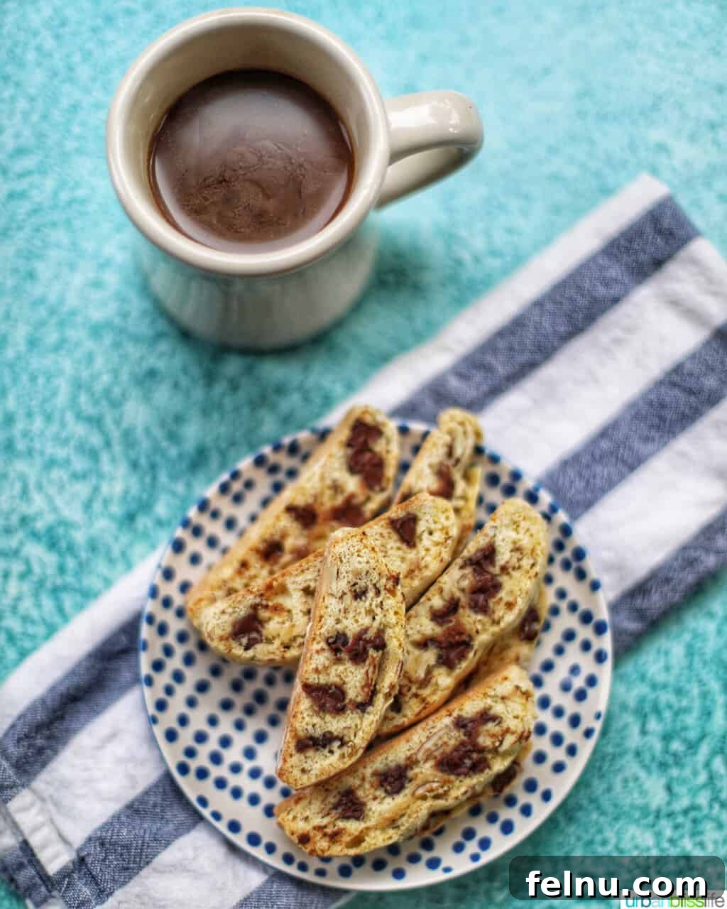 Toasted Almond Chocolate Chip Biscotti 14 a cup of coffee with chocolate chip almond biscotti beside it