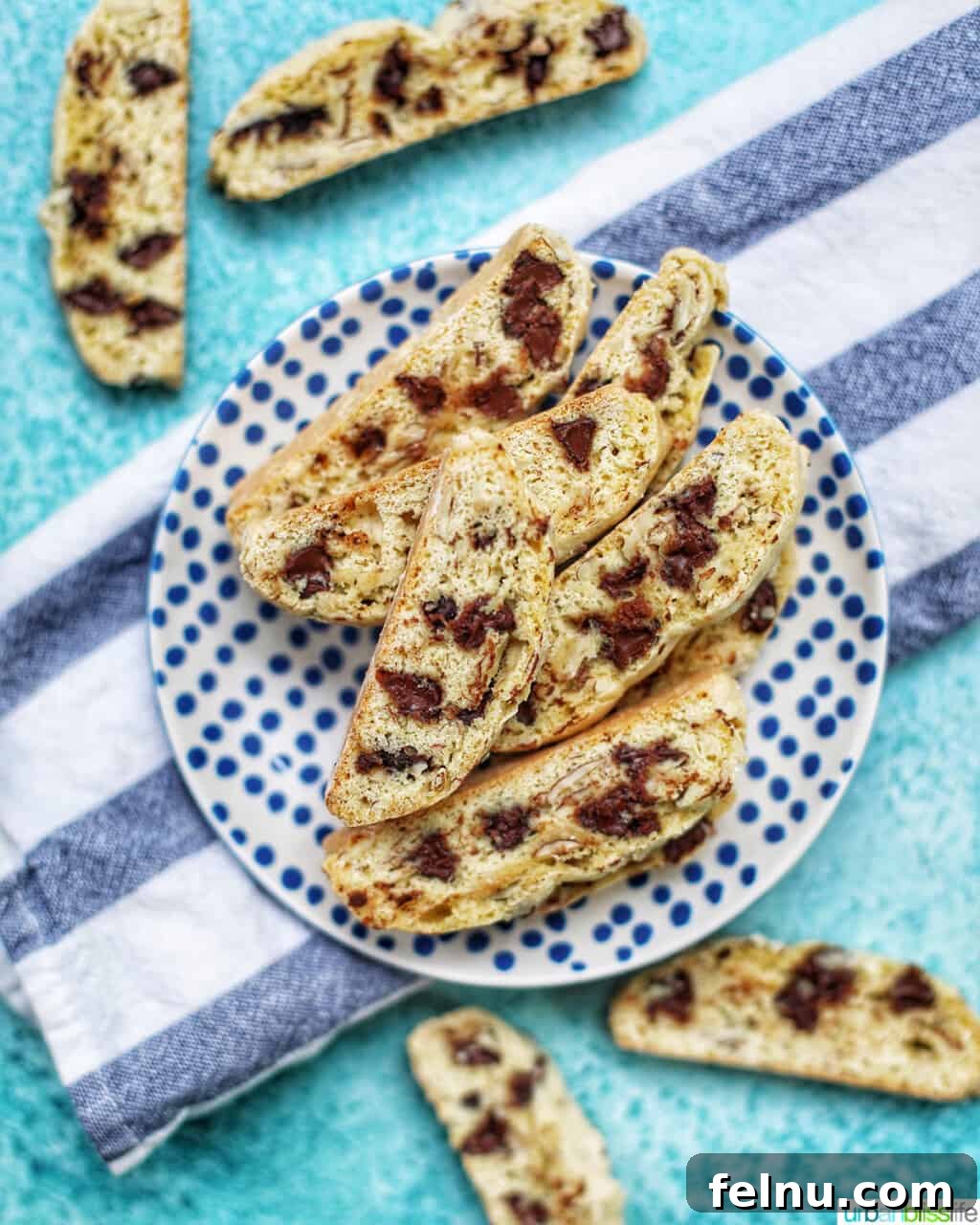 Toasted Almond Chocolate Chip Biscotti 3 chocolate chip almond biscotti elegantly arranged on a plate with a towel