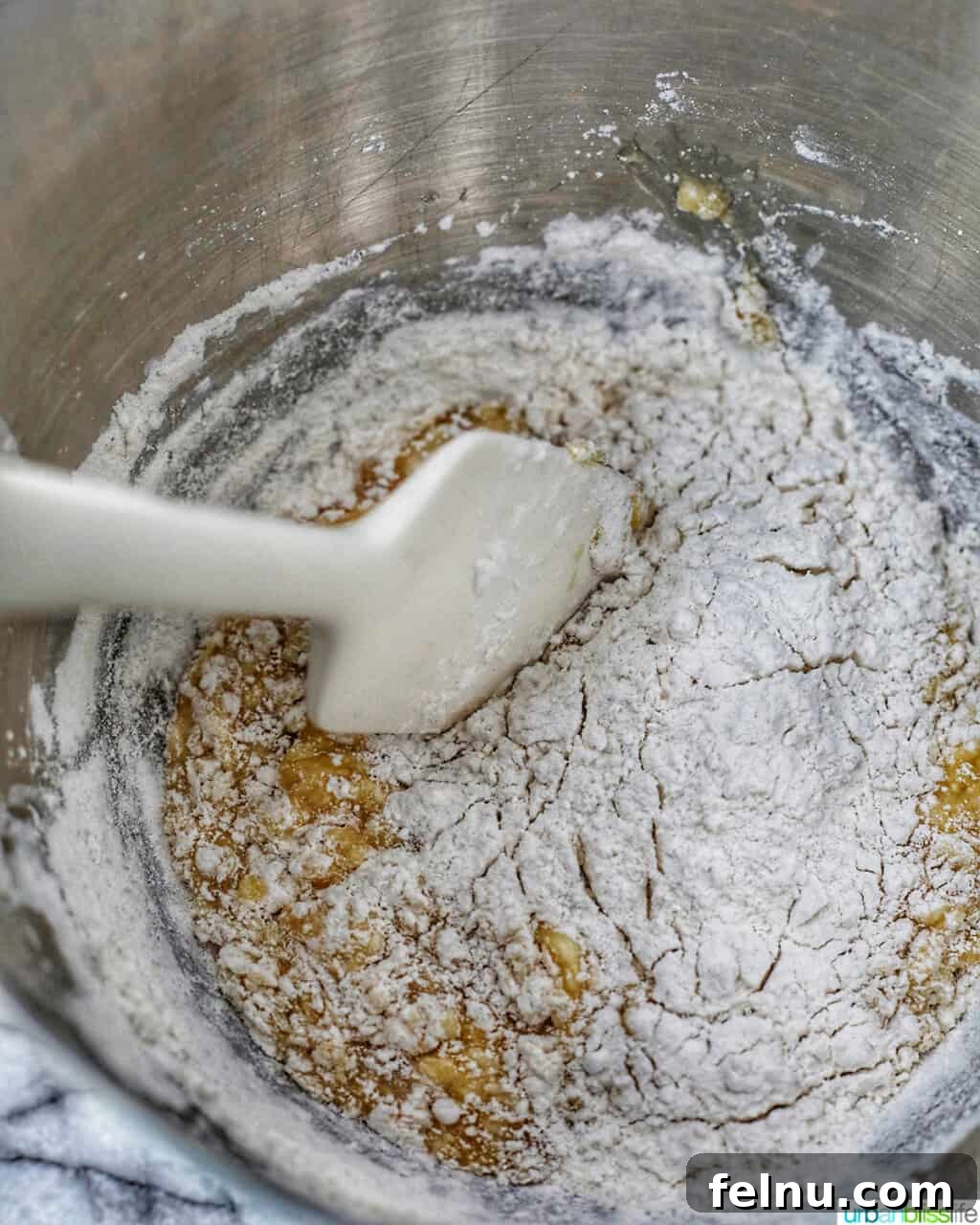 Toasted Almond Chocolate Chip Biscotti 7 gently folding dry ingredients into the wet mixture for biscotti