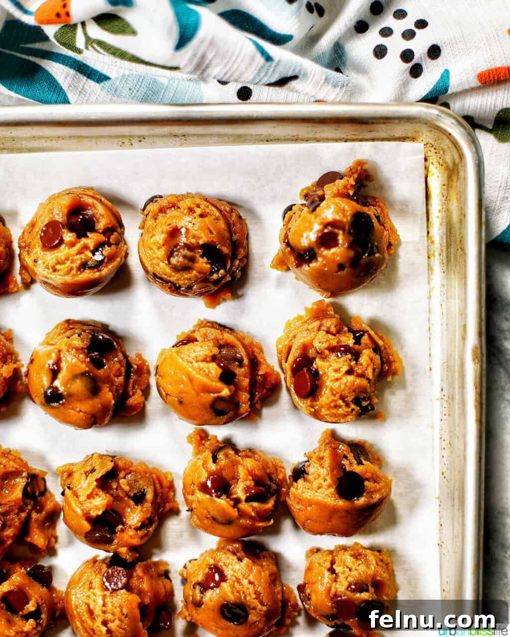 Golden Brown Butter Espresso Chocolate Chip Cookies 13 Scoops of chocolate chip espresso cookie dough on a parchment-lined baking sheet