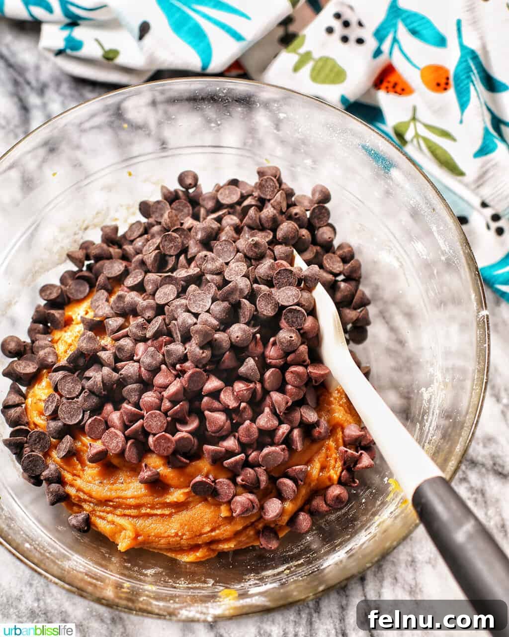Golden Brown Butter Espresso Chocolate Chip Cookies 10 Folding in chocolate chips into cookie batter with a silicone spatula