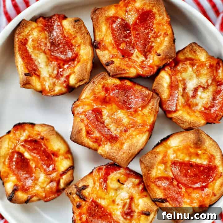 Effortless Pizza Bites 14 several mini pepperoni pizza cups on a plate.