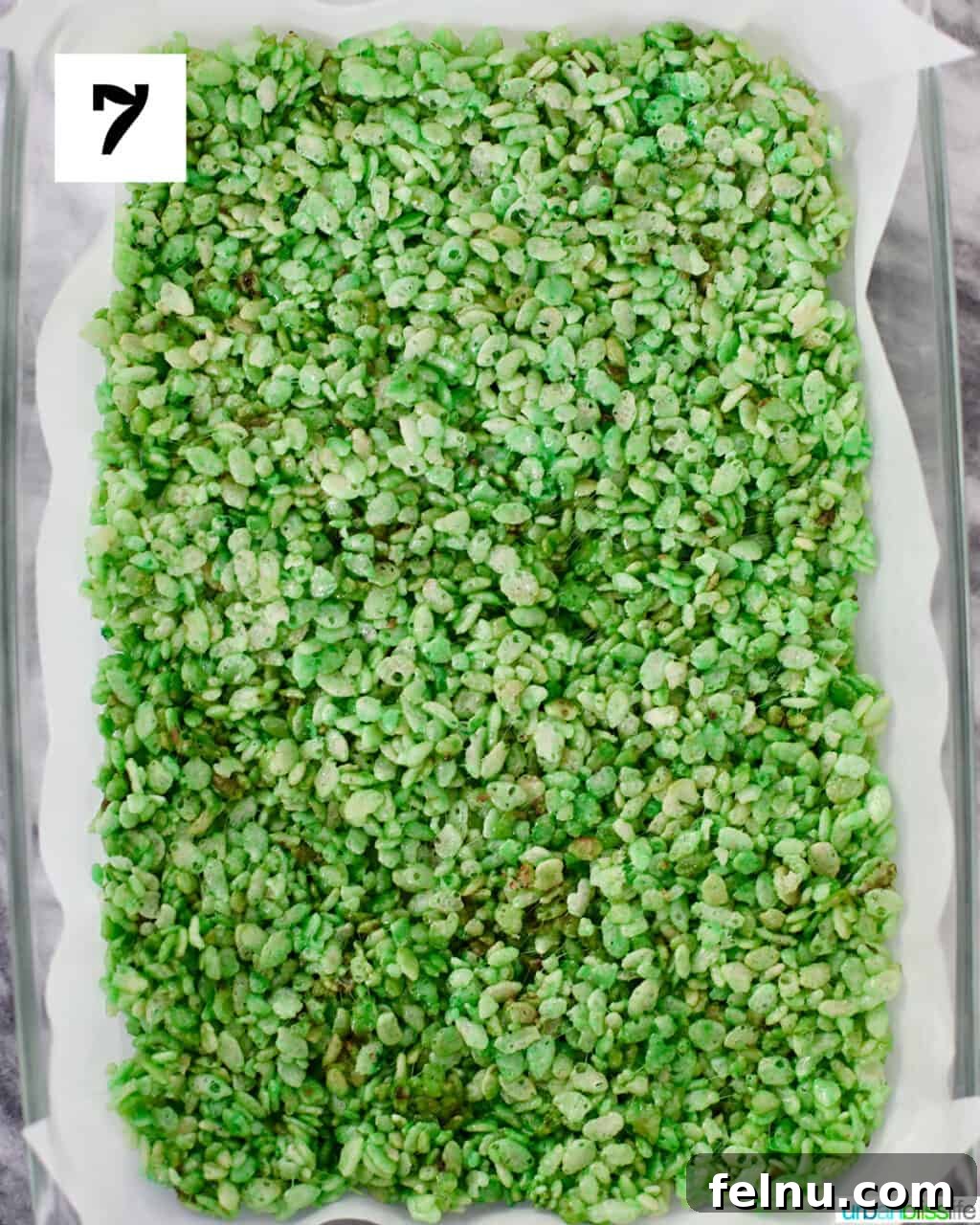 Frankenstein's Monster Munch 11 A full baking pan filled with green Rice Krispies treats, pressed down and ready to cool.
