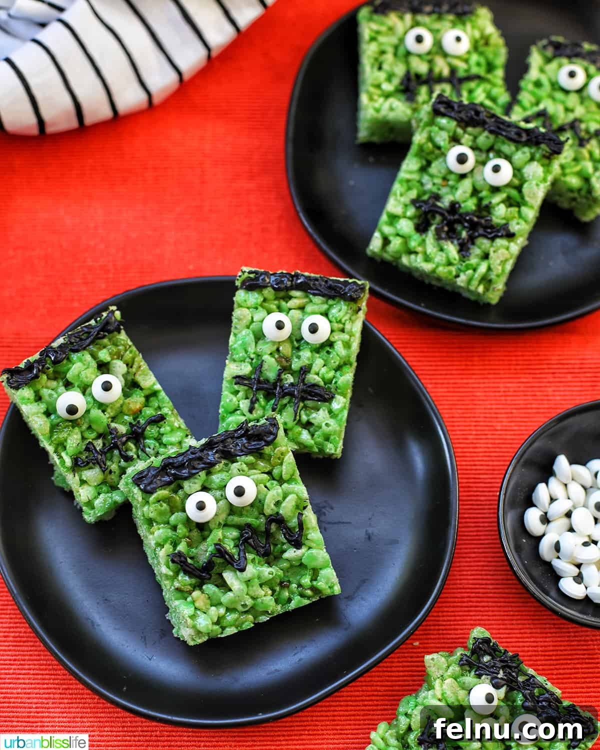Frankenstein's Monster Munch 3 Frankenstein Rice Krispie Treats arranged on black plates against an orange background, ready for a Halloween celebration.