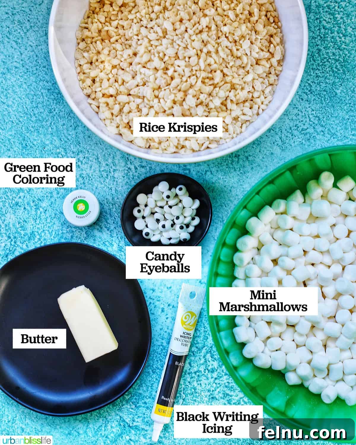 Frankenstein's Monster Munch 4 Various ingredients for Frankenstein Rice Krispie Treats laid out on a surface, including butter, marshmallows, cereal, food coloring, and candy decorations.