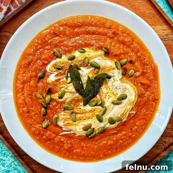 A bowl of vibrant vegan pumpkin soup, ready to be served.
