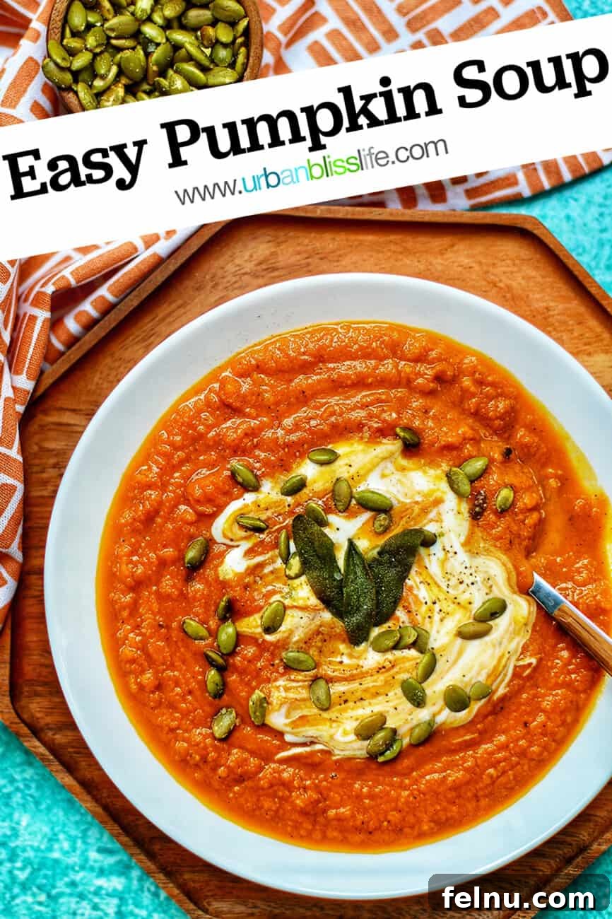 A beautifully presented bowl of creamy vegan pumpkin soup, garnished with crispy sage and pepitas, against a warm autumnal background, perfect for Pinterest.