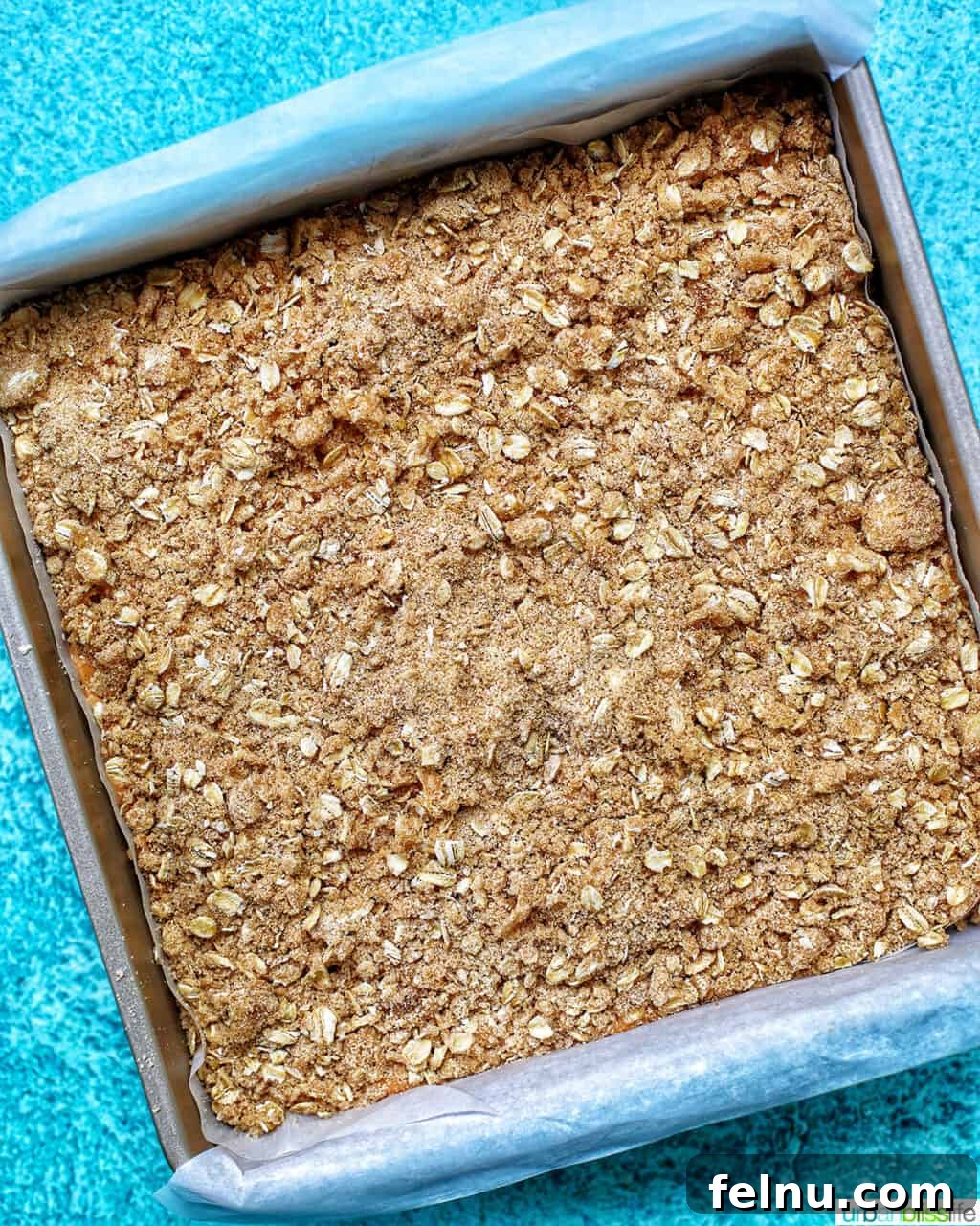 Autumn Spice Cheesecake Squares 17 Streusel topping on the Pumpkin Cheesecake Bars before baking.