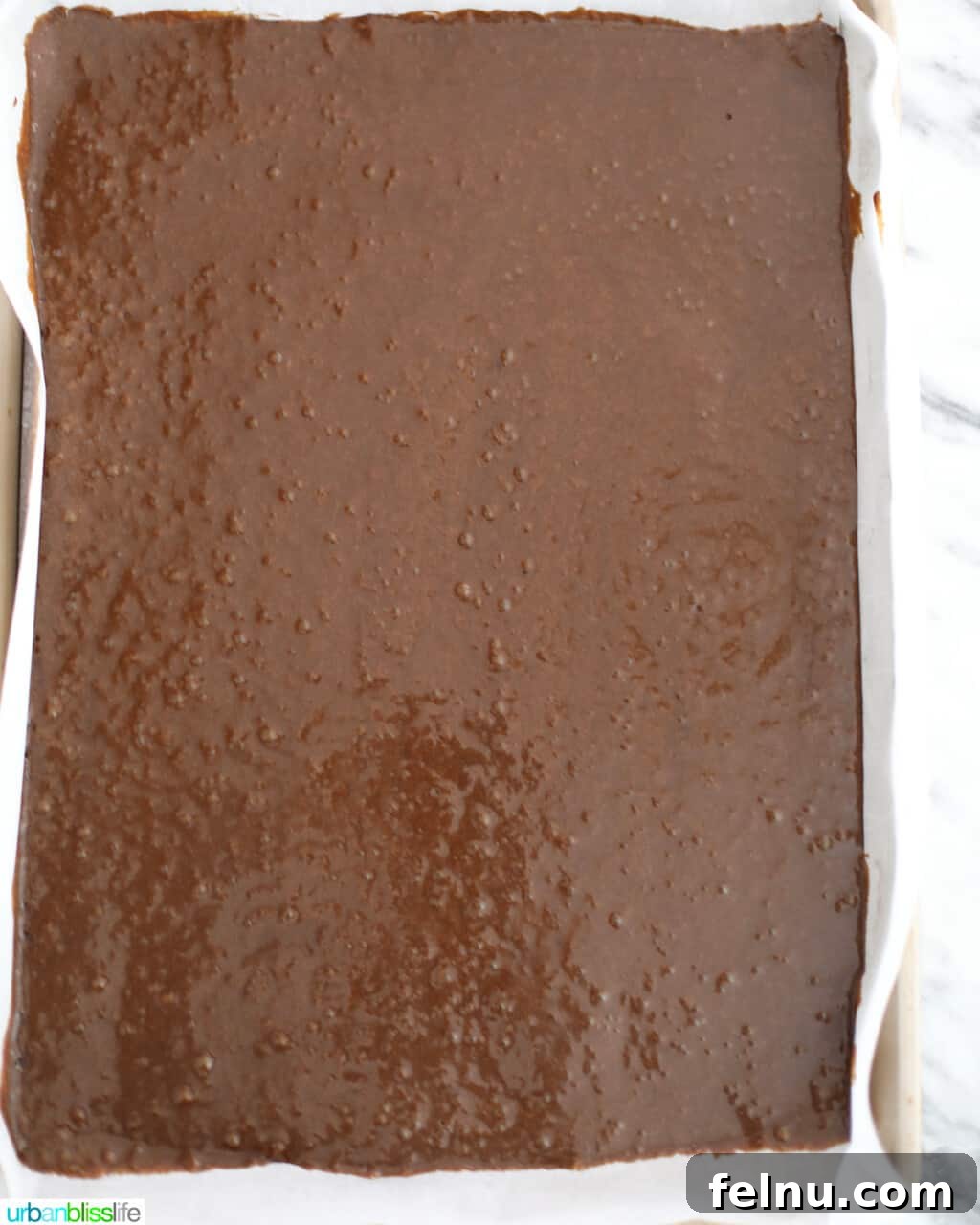 Gingerbread Cake Roll batter spread onto a sheet pan.