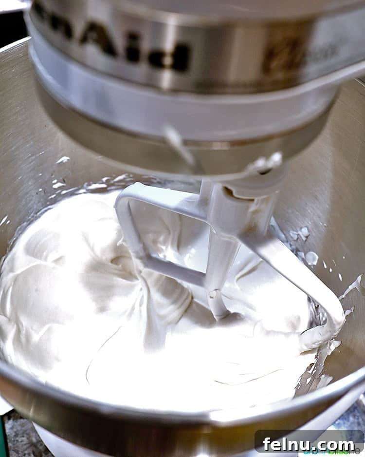 Gingerbread Swirl Cake 17 Cream cheese mixture being mixed in a stand mixer.
