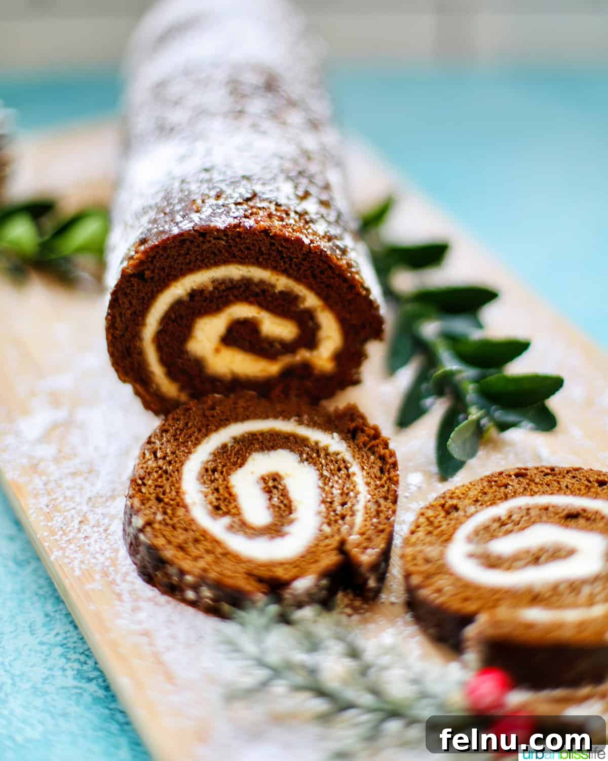 Gingerbread Swirl Cake 19 Finished Gingerbread cake roll with holiday trimmings, cream cheese filling, and Christmas decorations.