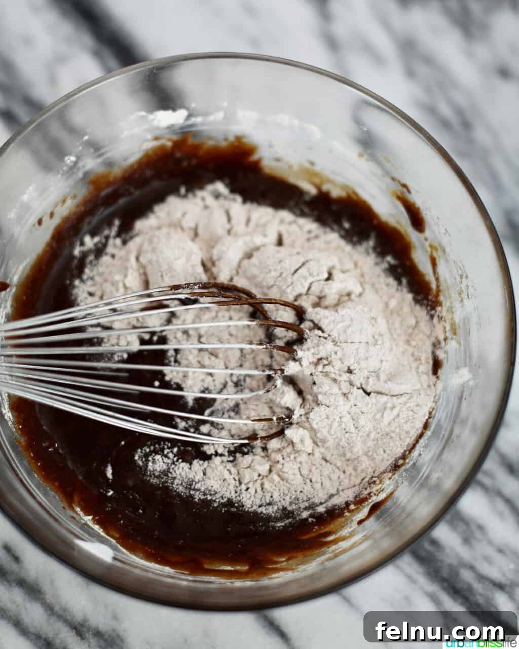 Whisking together dry and wet ingredients to make a gingerbread swiss roll.