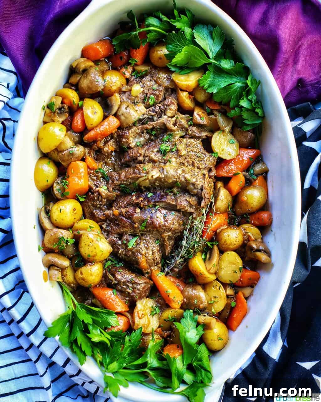 Succulent Dutch Oven Pot Roast 12 dutch oven pot roast with vegetables in a large white serving platter