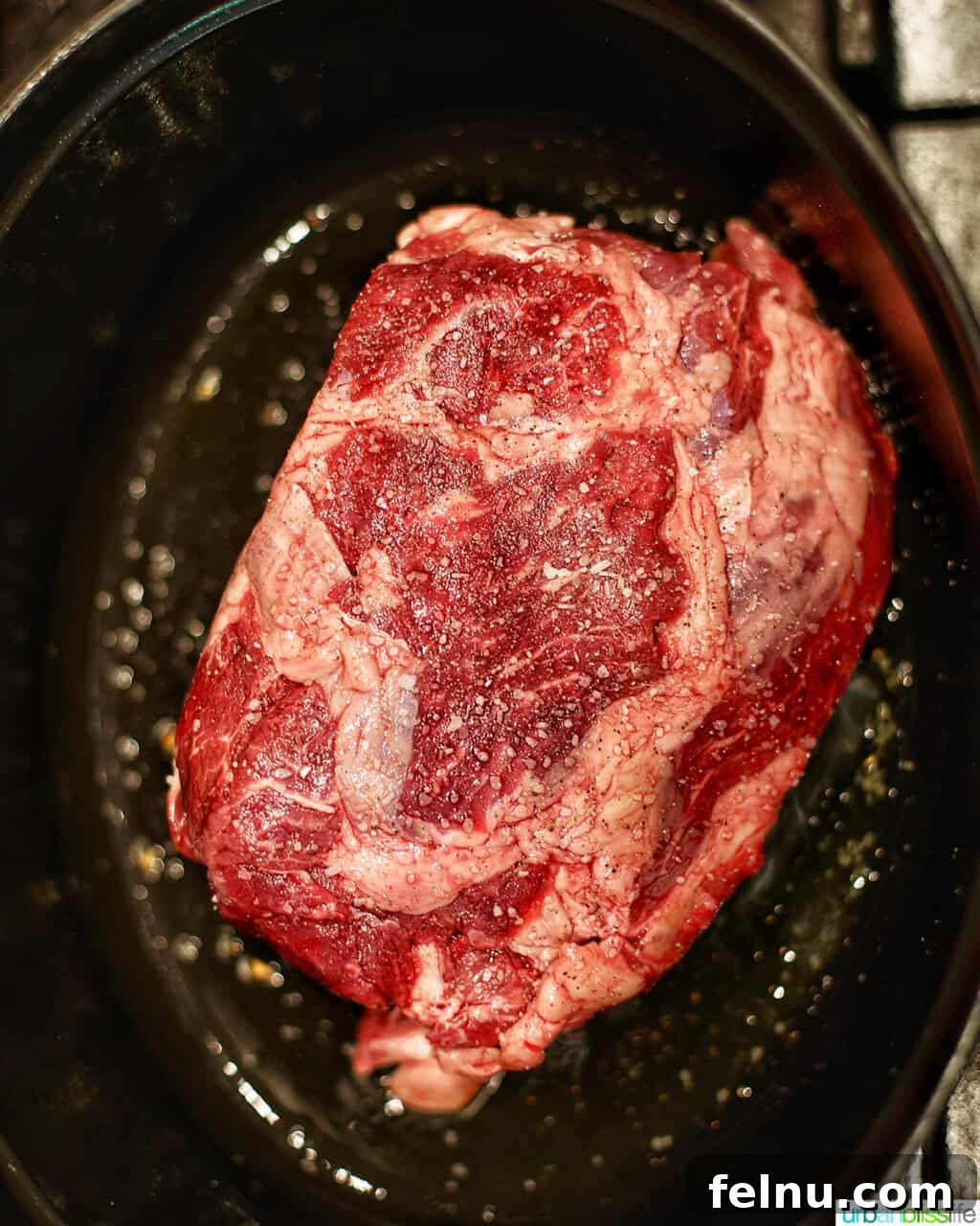 Succulent Dutch Oven Pot Roast 5 raw beef chuck roast in a dutch oven
