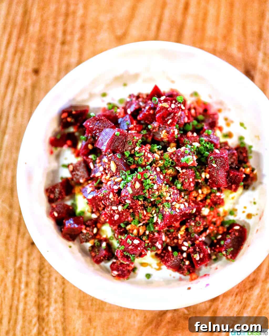 The Bullard Arms 6 A delicate white plate showcasing perfectly smoked beets, garnished with creamy goat cheese guacamole and crunchy walnuts, a signature starter at Bullard Tavern Portland.