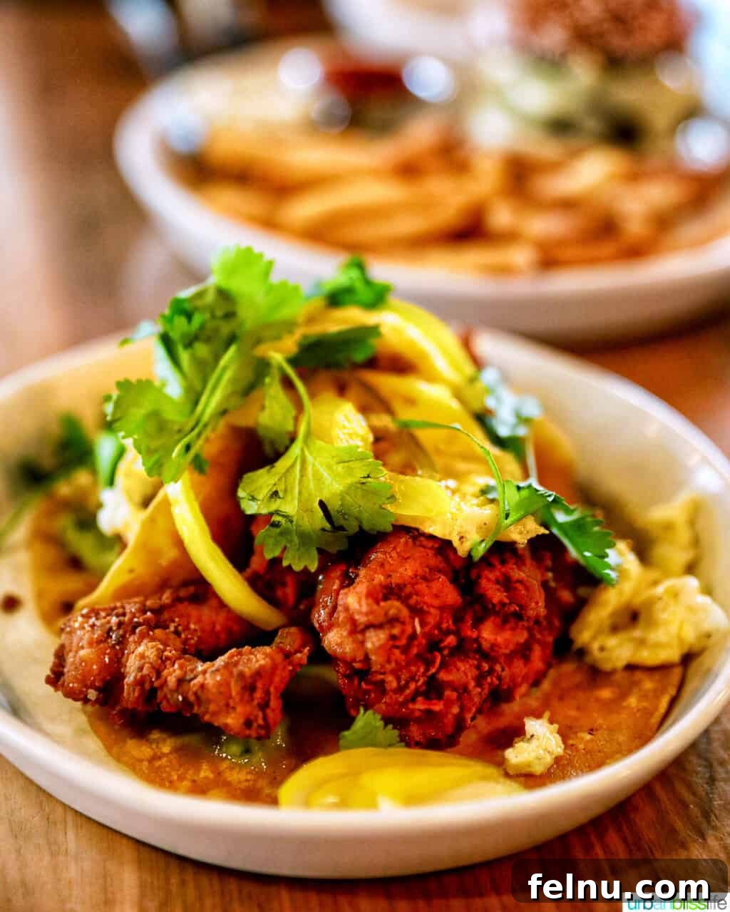 The Bullard Arms 7 Delicious fried chicken breakfast tacos, beautifully arranged on a plate at Bullard Tavern, promising a fusion of breakfast staples and vibrant Tex-Mex flavors.