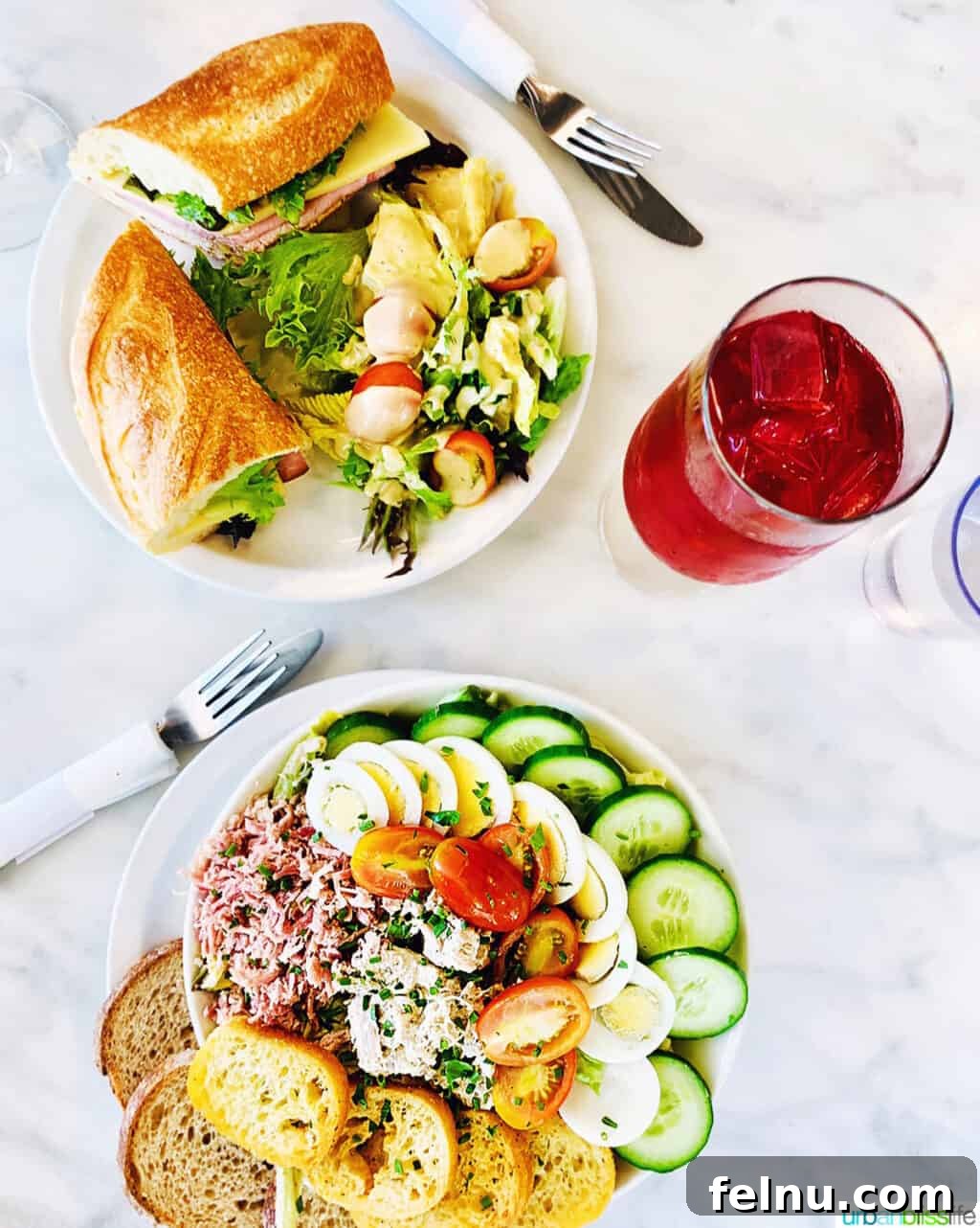 Portland, Oregon: A Food Lover's Paradise 4 Two plates featuring salads and sandwiches, accompanied by a refreshing drink at St. Honore Boulangerie, capturing the essence of French culinary delights in Portland.