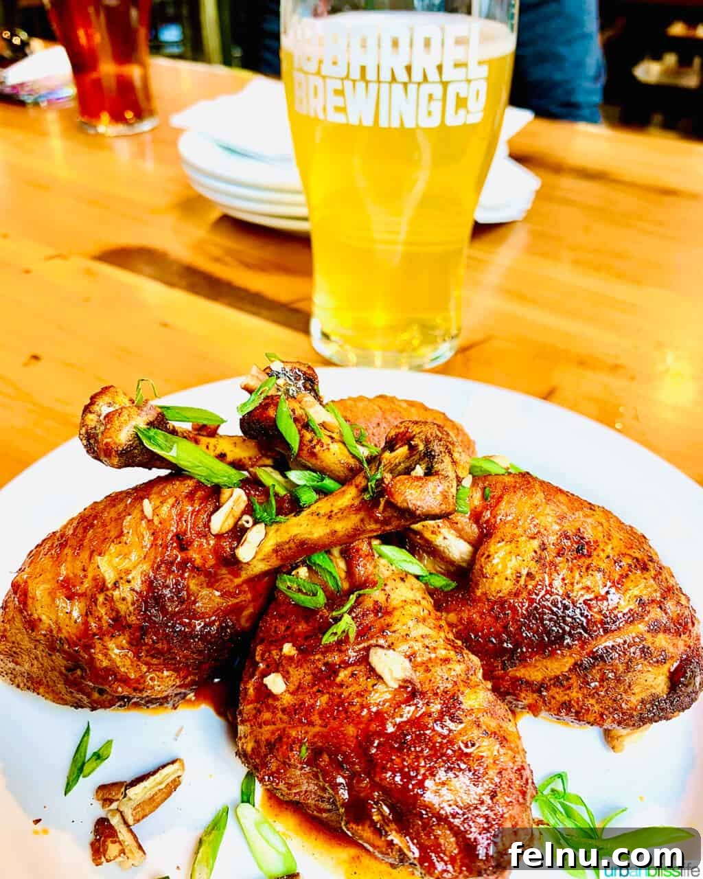 Portland, Oregon: A Food Lover's Paradise 5 A tempting plate of chicken drumsticks, paired perfectly with a refreshing beer in the background, showcasing the casual dining experience at 10 Barrel Brewing.
