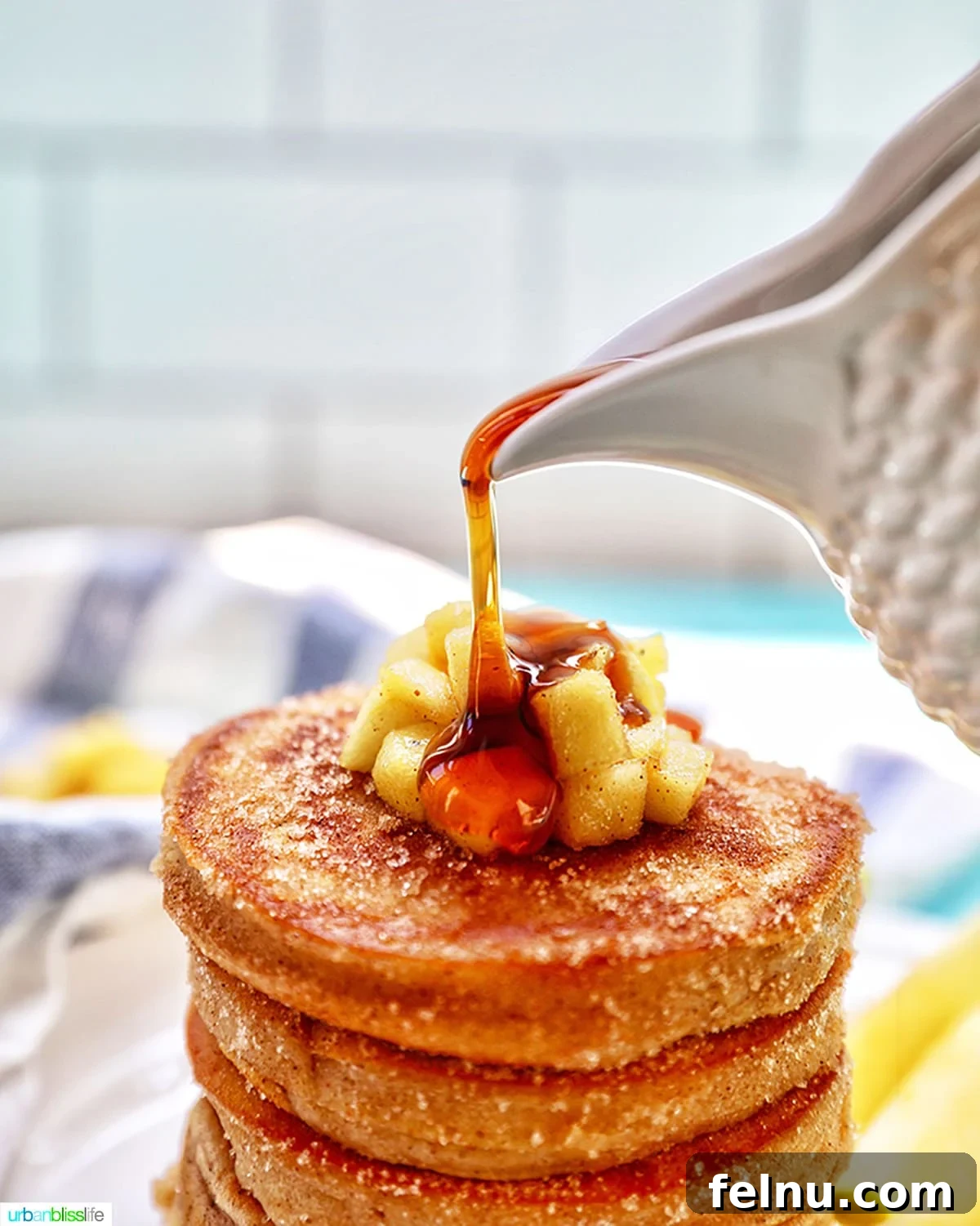 Fall's Apple Bounty: Sweet & Savory Recipes 2 pouring maple syrup over a stack of apple cinnamon pancakes