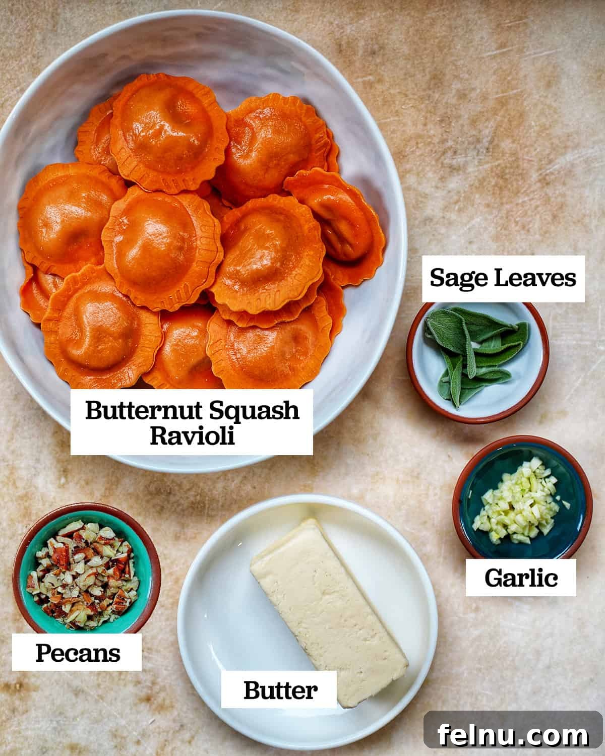 A flat lay photograph displaying the five simple ingredients required to make Butternut Squash Ravioli with Crispy Sage and Brown Butter Sauce.