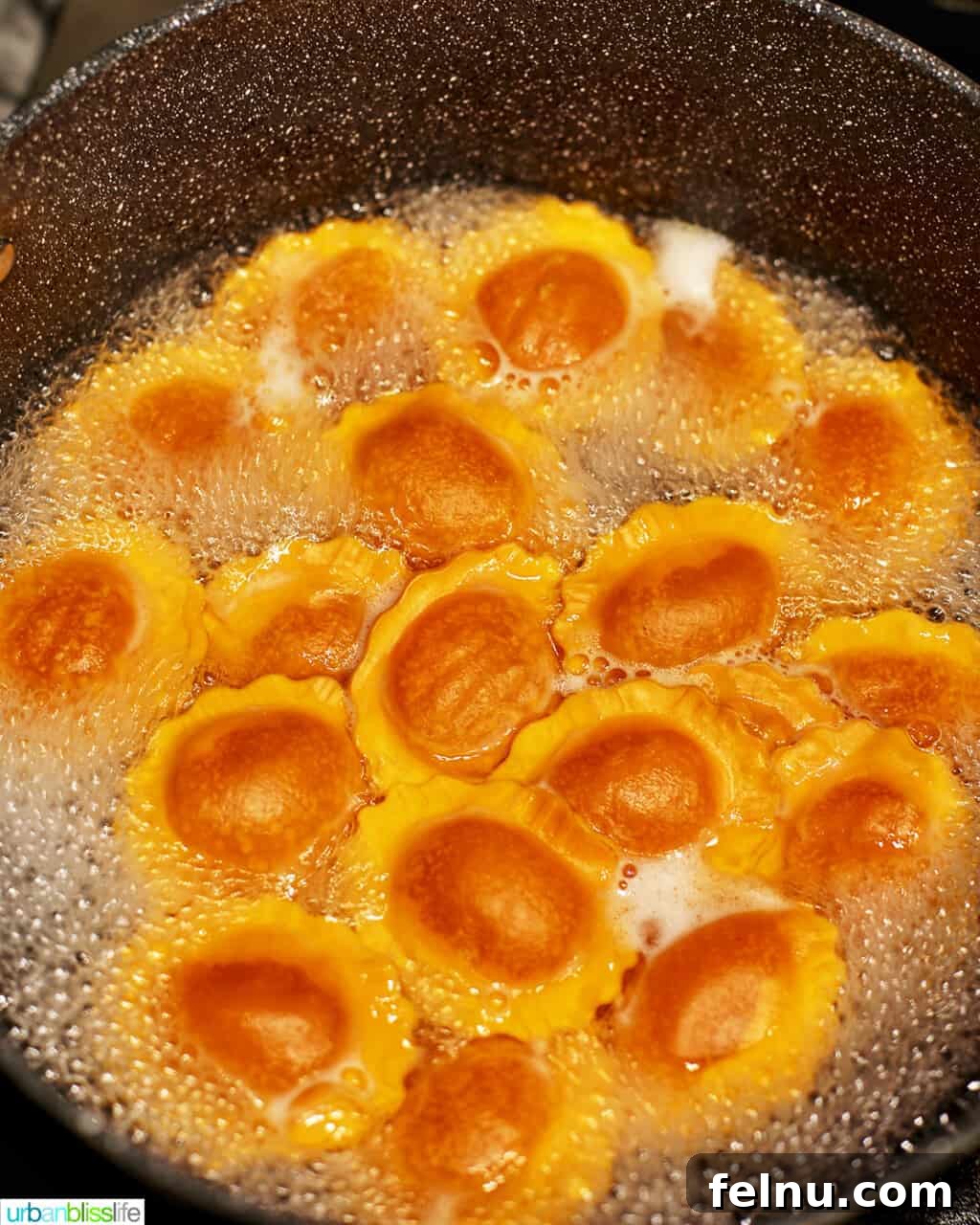 Cooking butternut squash ravioli in a pot of boiling water.