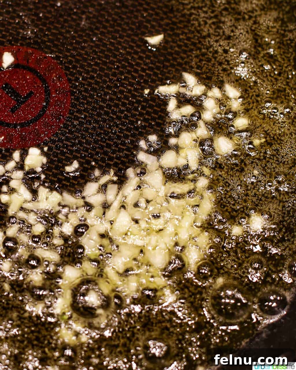 Minced garlic cloves sautéing in the browned butter in a skillet.