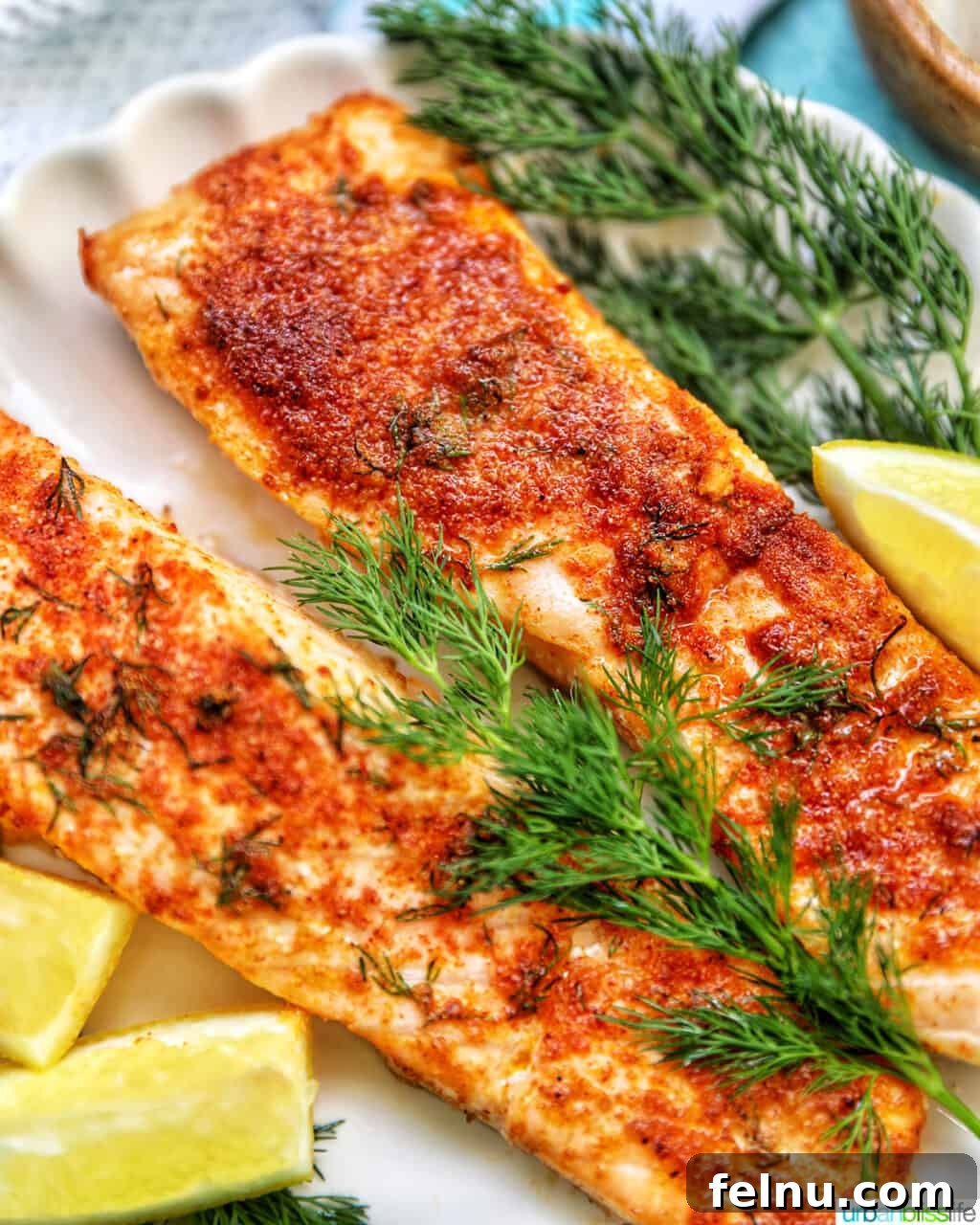 Perfect Air Fryer Salmon Every Time 2 Crispy air fryer salmon with fresh dill and lemon wedges, ready to serve.