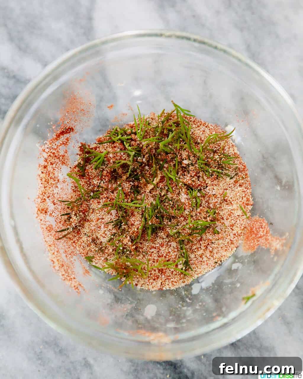 Perfect Air Fryer Salmon Every Time 6 A small bowl showing a mixed blend of paprika, garlic powder, dill, salt, and pepper.