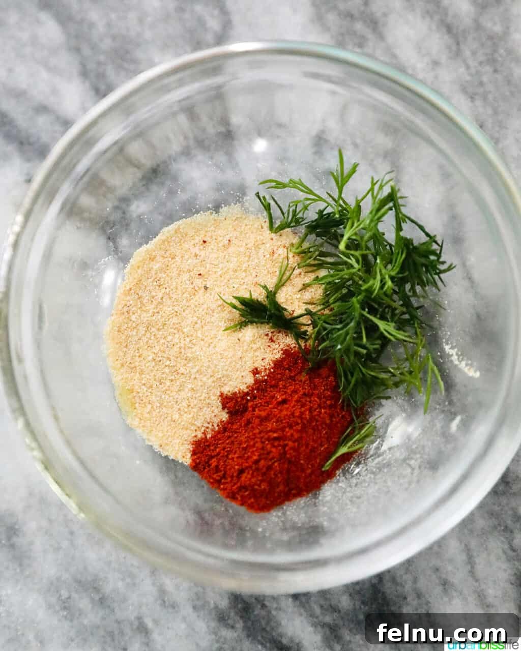 Perfect Air Fryer Salmon Every Time 7 Close-up of a vibrant spice mixture of paprika, garlic powder, and dill.
