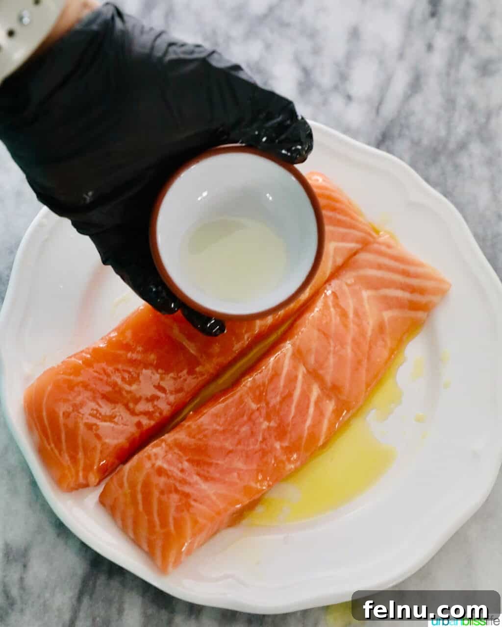 Perfect Air Fryer Salmon Every Time 9 Lemon juice being rubbed evenly over salmon fillets.