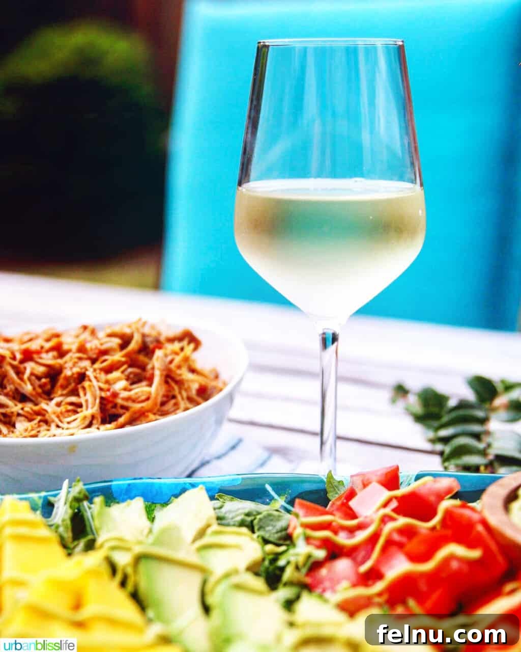One-Pan Veggie Tex-Mex Nacho Fiesta 13 Glass of white wine next to a plate of Mexican food, suggesting a great pairing