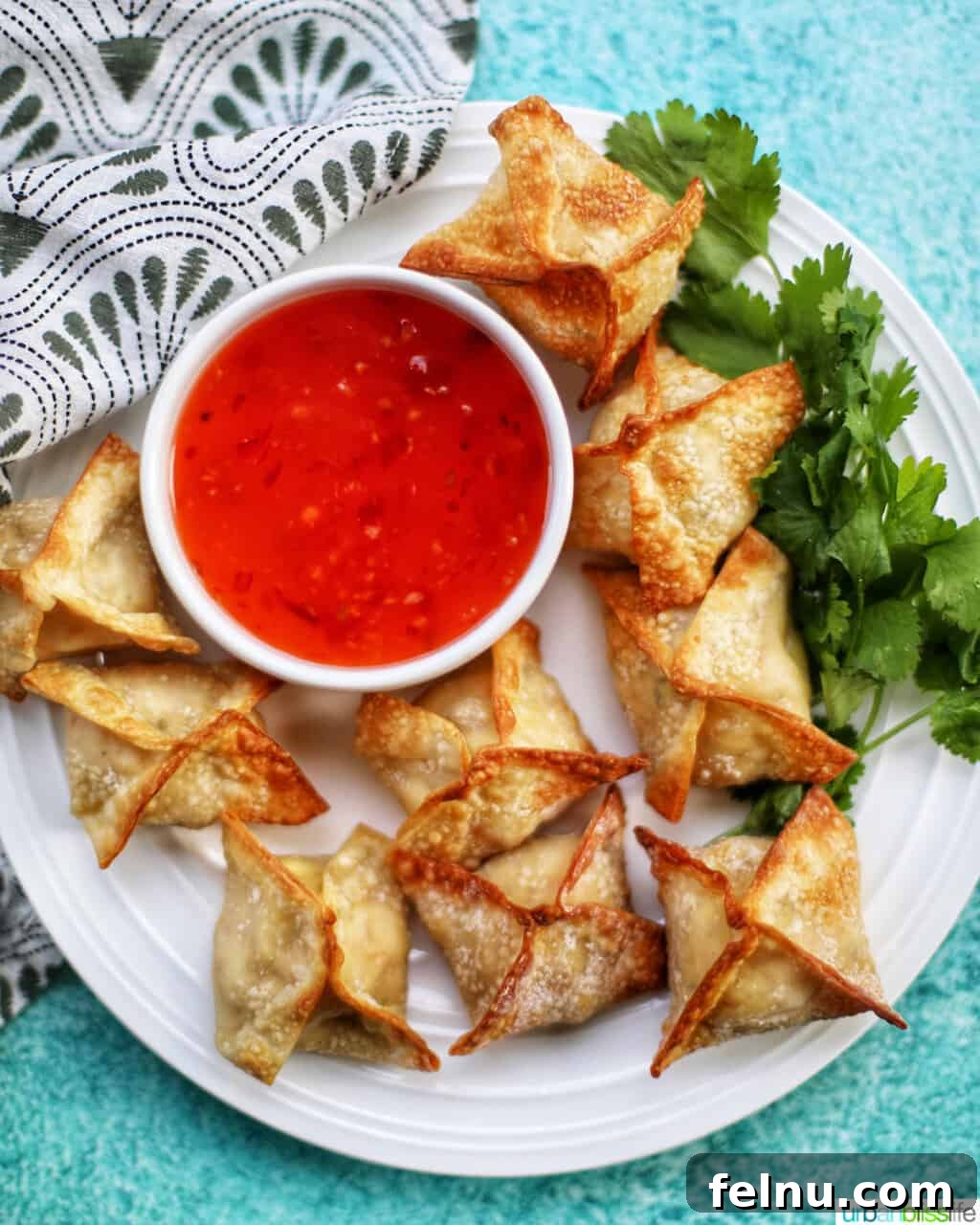 Perfectly Crispy Air Fryer Crab Rangoon 18 Cooked air fryer crab rangoon served on a plate