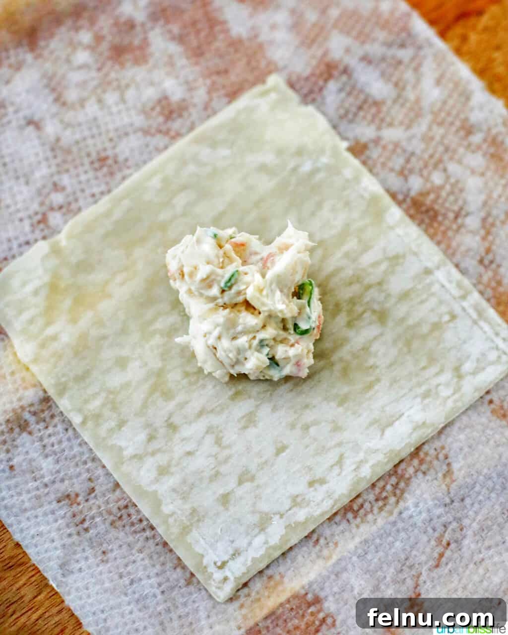 Perfectly Crispy Air Fryer Crab Rangoon 9 Cream cheese filling on a wonton wrapper, ready for folding
