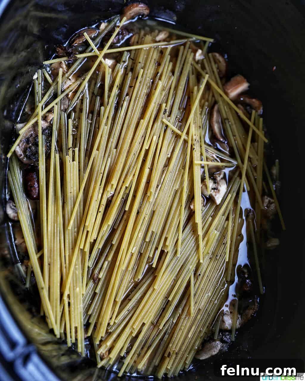 Slow-Cooker Turkey Tetrazzini Delight 12 Broken spaghetti in crockpot