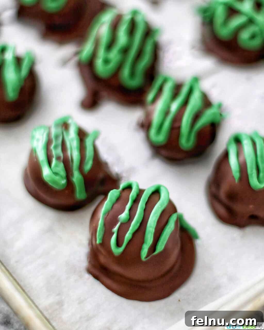Mint Oreo Bliss Bites 21 Green chocolate drizzle over Mint Oreo Truffles.