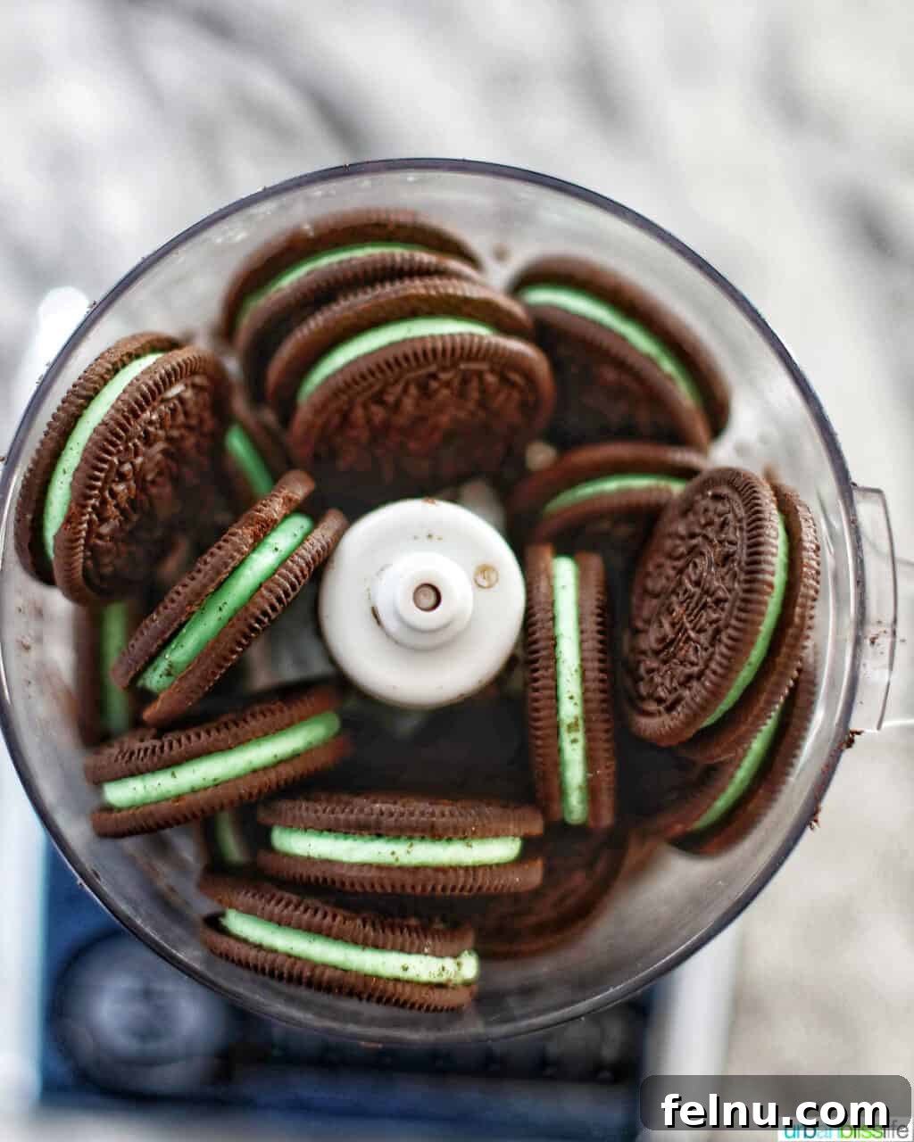 Mint Oreo Bliss Bites 4 Mint Oreos being processed in a food processor.